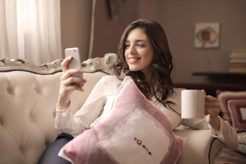woman-holding-smartphone-sitting
